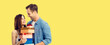 © vgstudio - Happy smile cute couple with gift boxes. Holiday sales shopping, consumer credit ad concept. Man and surprised woman, boyfriend and girlfriend, isolated over yellow background with free text space