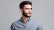 © pkproject - Professional studio portrait of a handsome man with neatly styled hair and a beard wearing a casual button down shirt with a neutral expression and gaze directed away from the
