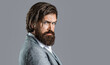 © Yevhen - Portrait of confident businessman man, suit with beard and hair alone looking seriously and confidently at the camera on gray background