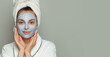 © artmim - Attractive healthy woman in blue clay cosmetic face mask indoor portrait. Facial treatment and skin care concept