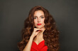 © artmim - Nice woman with long hair and make-up on black background. Gorgeous woman with curly hairstyle
