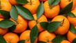 © Imam - Fresh ripe tangerines with vibrant green leaves creating a full-frame, textured background.