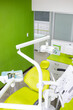 © GABRIEL - Modern dental clinic interior with green walls and chair