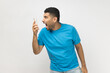 © khosrork - Angry despair man standing with mobile phone in hands, screaming while looking at cell phone.