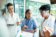 © Marko Geber - Adult medical team focused on patient care in hospital