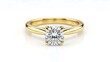 © Tgad - Close up of a gold ring with a large round diamond on a white background view
