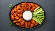 © NoorArt Studio - Buffalo chicken wings with ranch dip and celery sticks