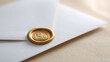 © Anastasiya Marchenko - Close-up of white envelope sealed with a golden wax stamp featuring a decorative emblem on textured surface