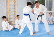 © JackF - Proficient judo master teaching his underage students martial art during workout session