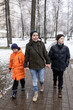 © Светлана Высокос - A woman with children on a winter walk. Children's playground with slides and swings
