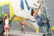 © JackF - Young girl in sportswear practicing rock climbing on climbing wall