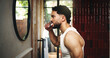 © peopleimages.com - Man, morning and brushing teeth with mirror in bathroom for dental hygiene or fresh breath in home. Profile, male person or cleaning mouth with toothbrush for grooming, oral or gum care in house