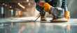 © Menganga - Worker polishes surface floor using power tool