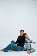 © Any Grant - mom with a baby boy on a white isolated background hugging, motherhood, mother with a teenage son
