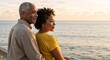 © Vasiliy - Mature african american couple embracing by the ocean at sunset. Senior man and woman looking towards the future together. Retirement and life planning concept