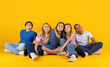 © Anastasiya - Group of preteen children sitting closely and looking upward with smiles on bright yellow studio background. Friendly pupils expressing curiosity, unity and a hopeful school lifestyle mood