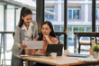 © Songsak C - A young business team is working on a business report document on the office desk. Brainstorming Business People Design Planning, Brainstorming Planning Partnership.