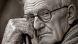 © A2Z AI  - A grayscale portrait of an older man with deep wrinkles, wearing glasses, and holding a cane. His face is thoughtful, etched with the passage of time, capturing a moment of quiet introspection.