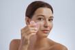 © Buyanskyy Production - Woman Massaging Face with Rose Quartz Gua Sha Tool for Skincare Routine