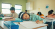© peopleimages.com - Tired, child and student sleeping in classroom for education, learning fatigue and boring lesson. Exhausted, kid and nap on desk for study burnout, school pressure and overworked with academic exams