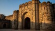 © Nadeem - Imposing Stone Entrance Gate of an Ancient Fort at Sunset with Cracked Walls
