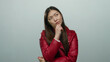 © Krakenimages.com - Woman pondering thoughtfully against a white background, wearing a red jacket with long dark hair, showcasing contemplation and expression