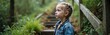 © Vadym - Young girl stands on forest stairs looking up thoughtfully. She wears a denim jacket and has braided blonde hair. Green plants surrounds her, suggesting a peaceful nature setting.