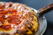 © heather linn photo - Close up of the crust on a pepperoni pizza served at a modern pizza restaurant