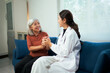 © Parichat - Asian doctor consulting elderly patient during home visit