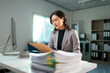 © Parichat - Female professional managing documents and paperwork in office