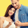 © vgstudio - Love, relationship, new parents and happy family concept - joyful young cute couple, husband, wife finding out results of pregnancy test, isolated bright yellow color background. Square image
