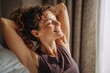 © Iftikhar alam - Happy woman stretching her back and smiling with joy in a bright room during the morning