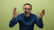 © Krakenimages.com - Senior man gestures passionately on an isolated yellow background wearing glasses and blue shirt