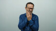© Krakenimages.com - Hispanic man experiencing tooth pain against a white background, clutching his jaw with a pained expression, isolated in a senior mature context showing dental discomfort.