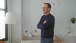 © Krakenimages.com - Man standing in a cozy bedroom by a crib with decorative items and a teddy bear on the shelf, creating a warm, inviting home environment.