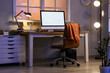 © Pixel-Shot - Workplace with blank computer monitor in office at night
