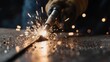 © Suliyati - Close-up of a welder working on metal with sparks flying.