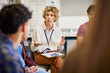 © Rido - High school counselor in conversation with group of multiethnic  students