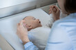 © Laia Balart - Mother gently holding baby's hands showing closeness and care