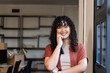 © Wavebreak Media - African American woman standing at office near window and shelving while monitoring smartwatch