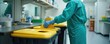 © Viktor - Medical pro in protective scrubs, gloves disposes waste in lab. Handles biohazard materials safely into yellow bins. Ensures strict hygiene. Practicing proper waste segregation for healthcare