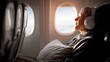 © Anat art - Passenger Enjoying Music With a Pillow While Seated in an Airplane Armchair During a Flight in the Afternoon Sunshine