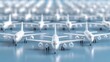 © lililia - White plastic toy airplanes are spread across a blue background, creating a minimalist air travel themed design with ample space for text