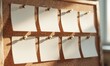 © Endang - Blank sticky notes affixed to a cork board, back lit by sunlight