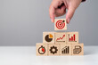© MOHAMED - business strategy, Action plan, Goal and target, hand stack woods block step on table with icon about business strategy and Action plan. business development concept. copy space