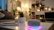 © phy - A smart speaker with colorful lights on a table in a cozy living room with a couch, potted plants, and a TV in the background.