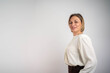 © Nenad - Middle age beautiful businesswoman standing over isolated white background looking to camera