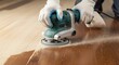 © DigitalSpace - Guided orbital sander removing old varnish from hardwood floor with visible sanding pattern transformation showcasing expert home flooring restoration tools.