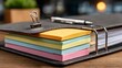 © Eqan - Organized business binder with vibrant colored sticky notes and a sleek silver pen on a wooden desk, perfect for planning and productivity
