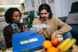 © Mediteraneo - Young couple reviewing bills together